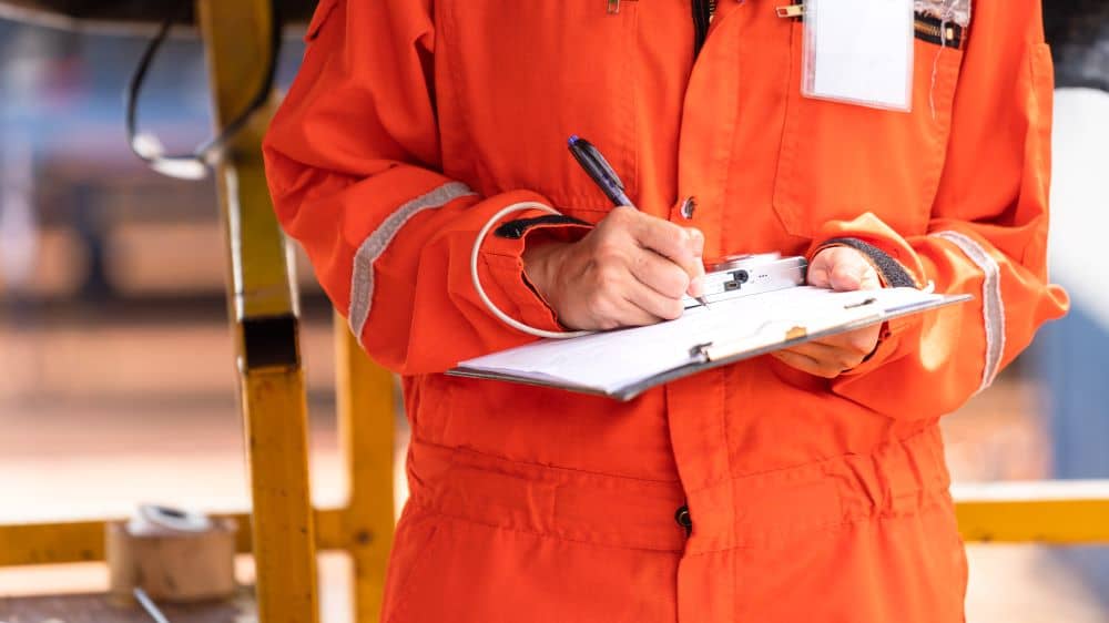 specialist in orange suit with paper